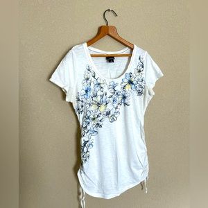 White with floral print, cinched sides maternity shirt.